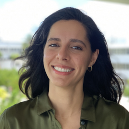 Headshot photo of Dr. Ana Tarano. She wears a dark olive green dress shirt.